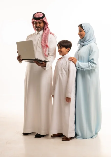 Following online classes and making a video call through a laptop, a portrait of an Arab Saudi Gulf man holding a laptop standing with his wife and son, a family atmosphere filled with love, connection, and stability, full-body shot, white background.