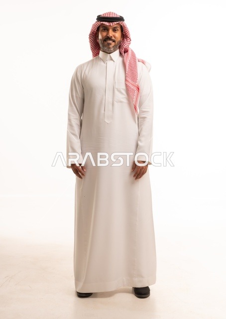 Facial expressions of a smile, hands on the side, attention to appearance and elegance, expressions of joy and happiness, a portrait of a Saudi Arabian Gulf man wearing traditional attire, a young Saudi man, the concept of expression through gestures, full-body image, white background.