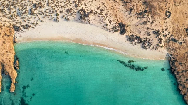 وجهة سياحية فاخرة في السعودية،، شواطئ جزيرة فرسان في جازان جنوب غرب الممكلة العربية السعودية، أمواج البحر الهادئة على شاطئ البحر الأحمر في وقت النهار