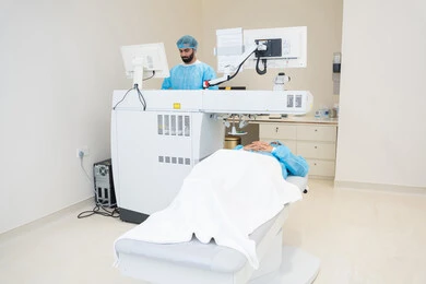 A thorough examination of the condition of the retina and cornea, utilizing radiographic imaging and modern techniques in the field of ophthalmology, employing advanced technology in visual diagnosis and treatment, an Arab Gulf Saudi doctor wearing sterile official attire reviewing eye radiology images on a computer inside the eye medical center, caring for eye health and improving vision, an interior background of the medical center.