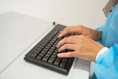 Gestures of focus and immersion, benefiting from radiographic imaging and modern techniques in the field of ophthalmology, using advanced technology in visual diagnosis and treatment, an Arab Gulf Saudi female doctor wearing sterile official attire monitors eye radiography images on a computer inside the eye medical center, a thorough examination of the condition of the retina and cornea, caring for eye health and improving vision, an interior background of the medical center.
