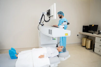 A thorough examination of the condition of the retina and cornea, caring for eye health and improving vision, utilizing radiographic imaging and modern techniques in the field of ophthalmology, using advanced technology in diagnosis and optical treatment, an Arab Gulf Saudi doctor wearing sterile official attire is reviewing eye radiology images on a computer inside the eye medical center, an interior background of the medical center.
