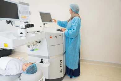 Utilizing radiographic imaging and modern techniques in the field of ophthalmology, employing advanced technology in visual diagnosis and treatment, an Arab Gulf Saudi female doctor wearing sterile official attire is monitoring ocular radiographic images on a computer inside the eye medical center, conducting a thorough examination of the retina and cornea, caring for eye health and improving vision, with an interior background of the medical center.