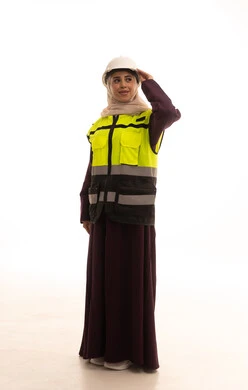 Standing with gestures of confidence, the concept of engineering project management, women's jobs and professions, working in the engineering sector, a portrait of an Arab Gulf Saudi female architect wearing a safety helmet and vest looking somewhere, full body, white background.