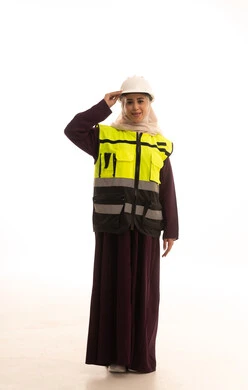 The concept of engineering project management, standing with gestures of confidence, women's jobs and professions, working in the engineering sector, a portrait of an Arab Gulf Saudi female architect wearing a safety helmet and vest looking at the camera with expressions of joy, full body, white background.
