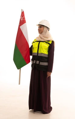 The concept of love for the homeland and belonging to it, celebrating the anniversary of the national day, pride in belonging to the country, pride in the symbols and the Omani flag, a portrait of a Saudi Gulf Arab engineer wearing a helmet and protective vest standing upright holding the flag of the Sultanate of Oman with expressions of self-confidence, full-body, white background.