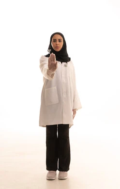 Expressions of firmness and seriousness, the concept of rejection, refusal, and discomfort, a request to stop and not approach, and a portrait of a Saudi Arabian Gulf Arab female doctor wearing a medical coat, extending her hands forward with her palm raised in gestures of prohibition against doing something, full-body image, white background.