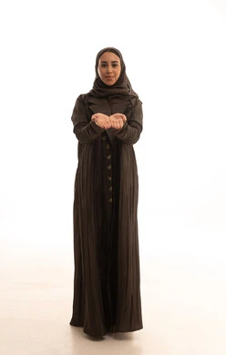 Standing upright with arms open in a gesture of lifting something, a close-up portrait of a Saudi Arabian Gulf woman wearing a hijab and an abaya, spreading her hands open upwards in a gesture of holding an item, looking at the camera with joy, against a white background.