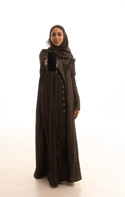 A blank black screen displayed on the mobile, gestures of happiness and joy, chatting with family and friends, using modern technological devices, a portrait of an Arab Gulf Saudi woman wearing an abaya and hijab holding a mobile phone, full-body, white background.