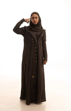 Hand signals and movements indicating this place (here), specifying the location of a certain object, a portrait of a Saudi Arabian Gulf woman wearing a hijab and an abaya pointing with her index finger to the right, full-body image, white background.