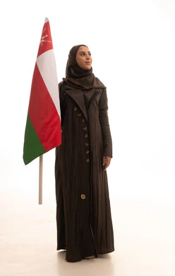 Cultures and national symbols, commemorating the founding of the state in 1775 AD, love for the homeland and belonging to it, a portrait of an Arab Omani Gulf woman wearing a hijab and an abaya holding the national flag of the country celebrating the anniversary of Omani National Day on November 18, full-body, white background. Cultures and national symbols, commemorating the founding of the state in 1775 AD, love for the homeland and belonging to it, a portrait of an Arab Omani Gulf woman wearing a hijab and an abaya holding the national flag of the country celebrating the anniversary of Omani National Day on November 18, full-body, white background.
