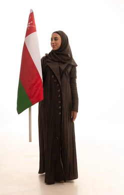 Commemoration of the establishment of the state in 1775 AD, love for the homeland and belonging to it, cultures and national symbols, a portrait of an Arab Omani Gulf woman wearing a hijab and an abaya holding the national flag of the country celebrating the anniversary of Omani National Day on November 18, full-body, white background.