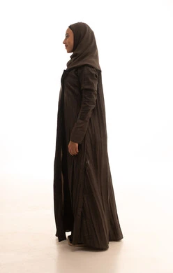 The concept of femininity and softness, the care and attention to external appearance, a side portrait of a veiled Saudi Arabian Gulf woman wearing an abaya standing upright, looking with gestures of self-confidence, expressions of joy and happiness, full-body, white background.