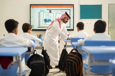 جودة التعليم في السعودية، معلم عربي خليجي سعودي يرتدي الثوب التقليدي والشماغ يقوم بمناقشة الدروس مع طلابه، مجموعة من طلاب عربيين خليجيين سعوديين يرتدون الزي المدرسي يقومون بتأديه الواجبات ، المشاركة الفعالة للطلاب مع المدرسين، التربية والتعليم بالمناهج المقررة للتلاميذ، حوارات ودية بين الاستاذ والطلاب