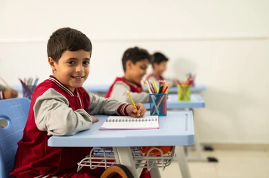 Preparation for the new school year, education in Saudi Arabia, completing school assignments, returning to school, a group of Arab Gulf Saudi students sitting in their seats and doing their homework.