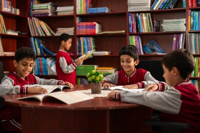 Enjoying reading school books, the concept of self-directed learning, an advanced educational environment, completing school assignments, Arab Saudi Gulf students wearing school uniforms sitting in the school library, education in the Kingdom of Saudi Arabia.