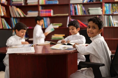 Education in the Kingdom of Saudi Arabia, the concept of self-education, a developed educational school environment, practicing the hobby of reading, a group of Arab Gulf Saudi students wearing traditional attire sitting in the school library, enjoying reading school books. Education in the Kingdom of Saudi Arabia, the concept of self-education, a developed educational school environment, practicing the hobby of reading, a group of Arab Gulf Saudi students wearing traditional attire sitting in the school library, enjoying reading school books.
