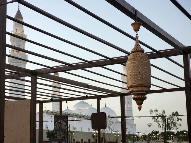 The outdoor courtyard of Quba Mosque in Medina during the day, a call for Muslims to perform prayer and draw closer to Allah Almighty, landmarks and sacred religious places in the Kingdom of Saudi Arabia, the illuminated minarets and domes, architectural engineering art and Islamic decorations in a modern style.