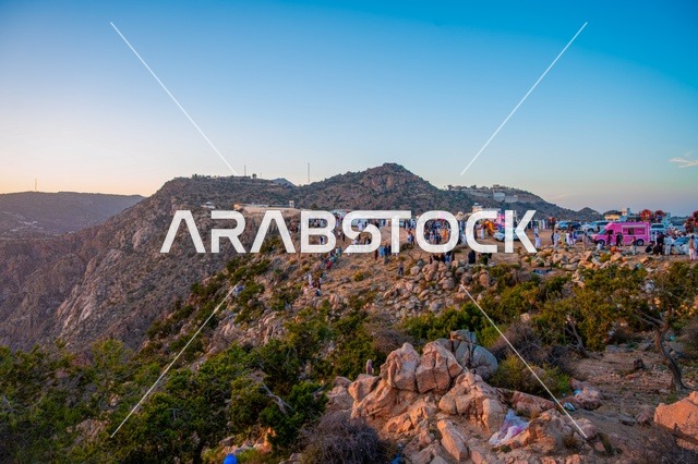 The breathtaking sunset over the Al-Shafa Mountains, Taif city, landmarks of the Kingdom of Saudi Arabia - a stunning mountainous view with a vibrant sky.