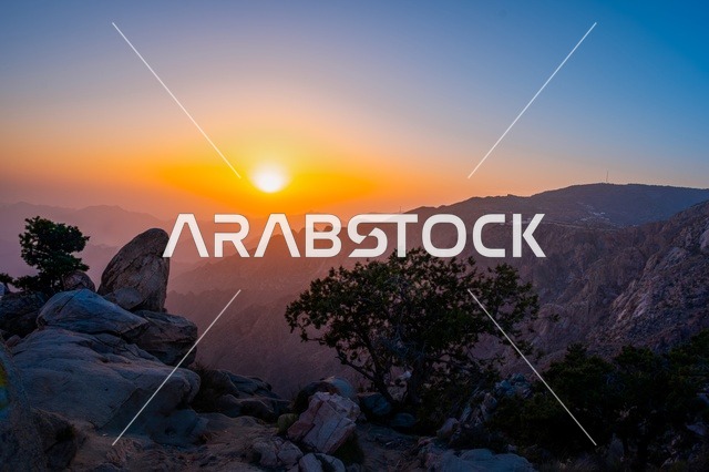 The breathtaking sunset over the Al-Shafa Mountains, Taif city, landmarks of the Kingdom of Saudi Arabia - a stunning mountainous view with a vibrant sky.