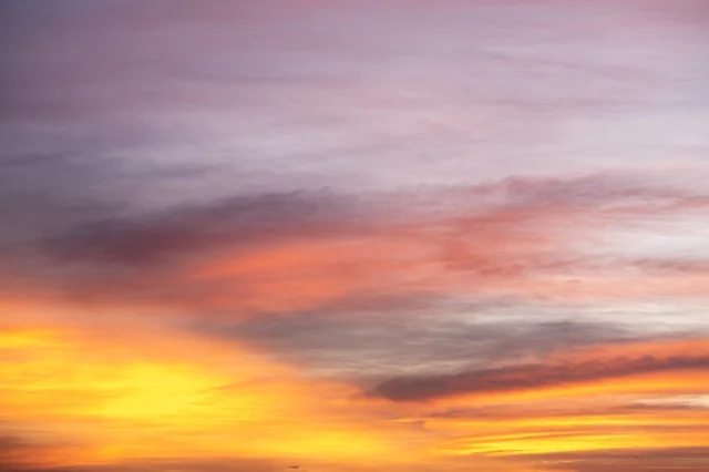 A mesmerizing scene of the sunset on Jeddah beach, the sky painted in warm colors, creating a stunning natural canvas on the waterfront.