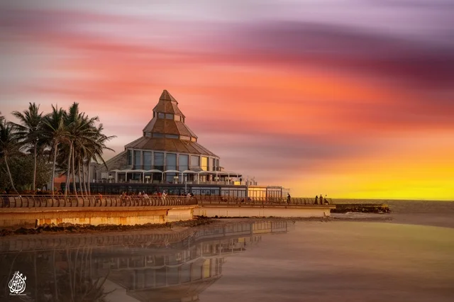 A mesmerizing scene of the sunset on Jeddah beach, the sky painted in warm colors, creating a stunning natural canvas on the waterfront.