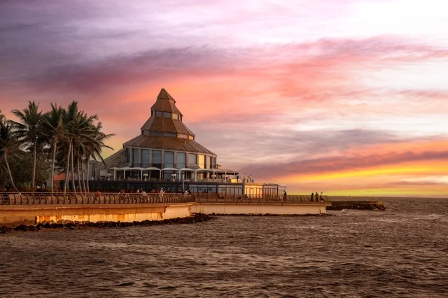 Stunning sunset view over Jeddah beach, with warm colors painting the sky and reflecting on the clouds, creating a breathtaking scene along the Red Sea waterfront.
