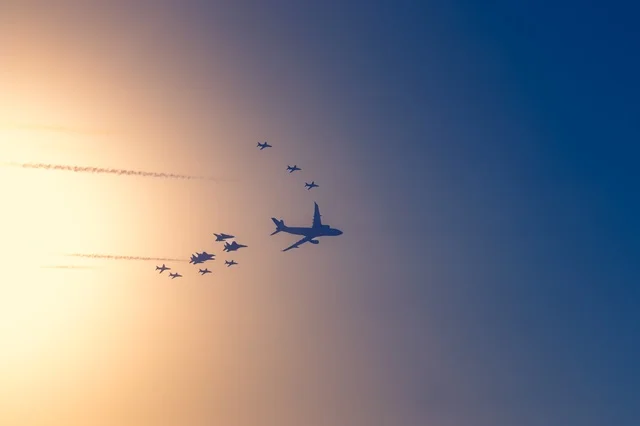 A group of green Saudi planes flying in the blue sky in the Kingdom of Saudi Arabia. An air show of planes during the celebrations of Saudi National Day on September 23, with recreational activities and events.