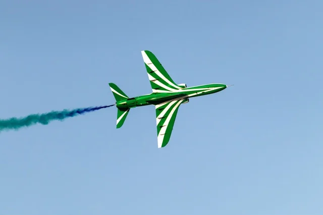 Aerial display of aircraft during the Saudi National Day celebrations on September 23, with recreational activities and events, a green Saudi plane flying in the blue sky of the Kingdom of Saudi Arabia. Aerial display of aircraft during the Saudi National Day celebrations on September 23, with recreational activities and events, a green Saudi plane flying in the blue sky of the Kingdom of Saudi Arabia.