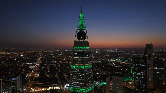 The Kingdom Centre Tower in Riyadh, Saudi Arabia at sunset, the towers of Riyadh, illuminated towers and skyscrapers, architectural art, the famous landmarks of Riyadh.