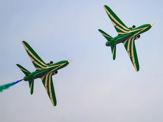 Aerial display of aircraft during celebrations, events and recreational activities, a group of green Saudi planes flying in the blue sky in the Kingdom of Saudi Arabia.