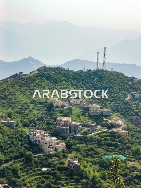 The enchanting nature in the city of Faifa in the Jazan region, southern Saudi Arabia, famous tourist spots, green plants and trees on the peaks and mountainous heights in the Jazan region, distinctive landscapes.