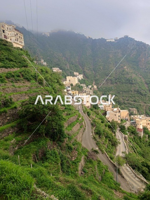 The enchanting nature in the city of Faifa in the Jazan region, southern Saudi Arabia, famous tourist spots, green plants and trees on the peaks and mountainous heights in the Jazan region, distinctive landscapes.