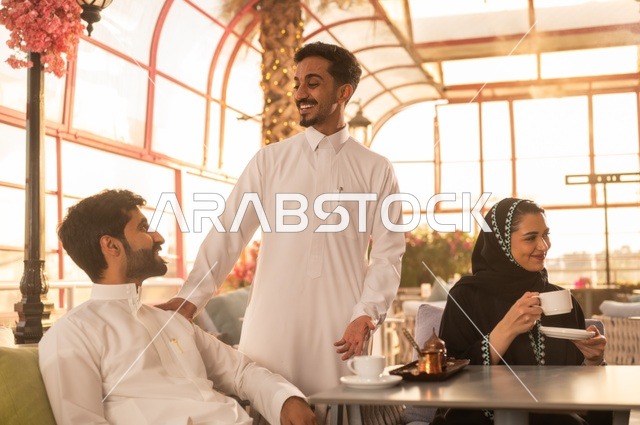 الاستمتاع بتناول المشروبات الساخنة، حوارات ونقاشات عائلية، قضاء وقت ممتع في الخارج، مفهوم الألفة والمحبة بين الأهل والأصدقاء, اصدقاء عرب خليجيون سعوديون يجلسون في احدى الكافيهات الراقية، ايماءات السعادة والسرور