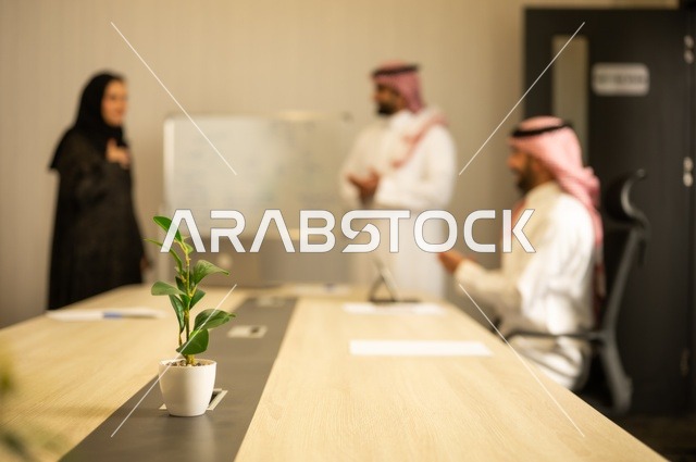 العمل الجماعي وروح الفريق، مناقشة خطط العمل، استخدام اللابتوب في تدوين الملاحظات، الاحترافية والتفاني في الإنجاز، فريق عربي خليجي سعودي في اجتماع داخل المكتب، ضمان فهم واضح وشامل للاعمال، توضيح العمليات والاجراءات المتبعة في الشركة