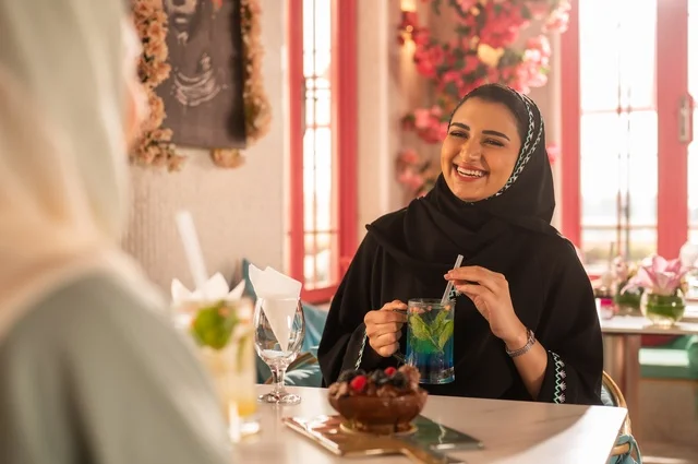 Having an enjoyable conversation among friends, a fun and social gathering, Arab Gulf Saudi friends sitting in a café, building social relationships, spending enjoyable times with friends, an upscale coffee shop in the Kingdom of Saudi Arabia, a meeting on the weekend.