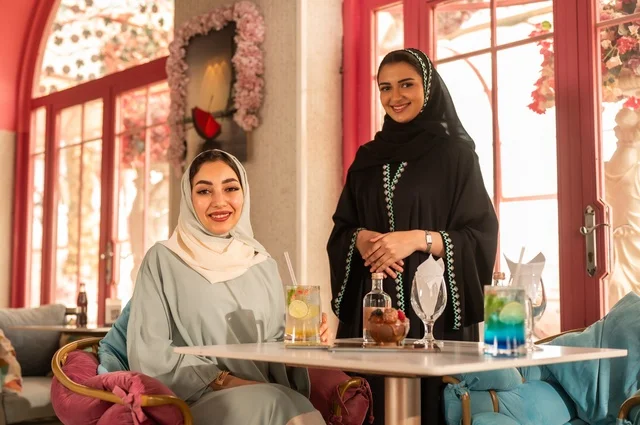 Having an enjoyable conversation among friends, a fun and social gathering, Arab Gulf Saudi friends sitting in a café, building social relationships, spending enjoyable times with friends, an upscale coffee shop in the Kingdom of Saudi Arabia, a meeting on the weekend.