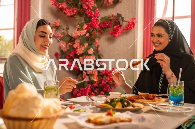 A luxurious restaurant in the kingdom, delicious food and meals, engaging in enjoyable conversations among friends, a fun and social gathering, Arab Gulf Saudi friends sitting in one of the upscale restaurants having lunch, building social relationships, spending enjoyable times with friends, a meeting on the weekend.