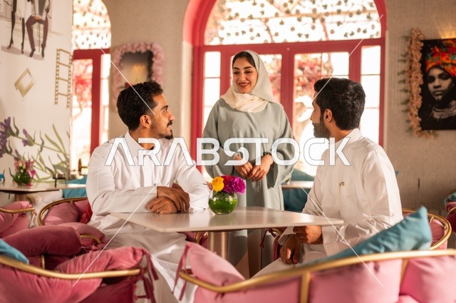 Sipping a favorite drink in a coffee shop, spending enjoyable times with friends, developing successful social relationships among people, discussing and conversing in a calm atmosphere, a picture of two smiling Saudi Gulf Arab colleagues sitting in one of the upscale cafes with expressions of happiness and joy.