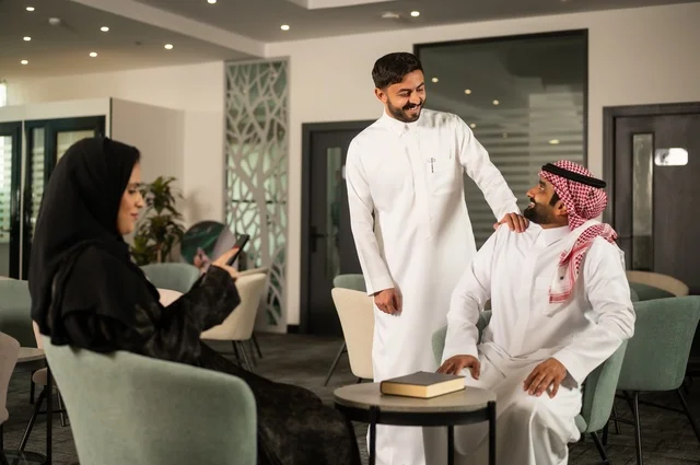 اجتماع عمل في الخارج، العمل الجماعي وروح الفريق، مناقشة الخطط والاستراتيجيات، استخدام اللابتوب في تدوين الملاحظات، الاحترافية والتفاني في الإنجاز، فريق عربي خليجي سعودي يتبادل الافكار والاراء، ضمان فهم واضح وشامل للاعمال