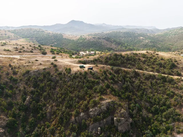 Mountain peaks and highlands in the Al-Namas governorate, natural places and areas in the Kingdom of Saudi Arabia, natural topography and rock formations, an aerial image of green trees and crops on the slopes of the mountains in the Asir region.