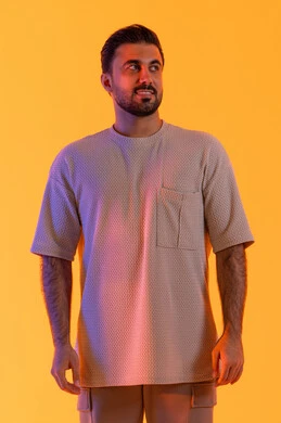 Attention to appearance and elegance, standing with confidence and uprightness, the concept of masculinity and self-confidence, a portrait of a smiling Emirati Gulf Arab man wearing casual attire looking at something, masculinity, strength, and self-confidence, full-body image, orange background.
