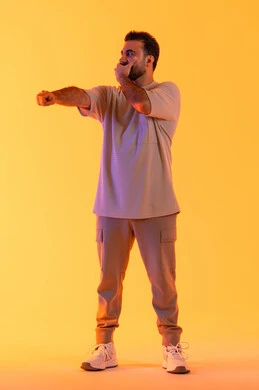 Expressions of joy and happiness, pointing with the index finger at something, a portrait of a young Arab Gulf Emirati man wearing casual attire with his hand on his mouth, a Saudi man looking at someone, full body, yellow background.