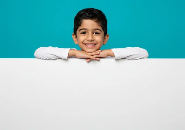Gestures of pleasure and happiness, interaction, fun and entertainment, portrait of a smiling Saudi Arabian Gulf boy wearing casual clothes looking at the camera, blue and white background