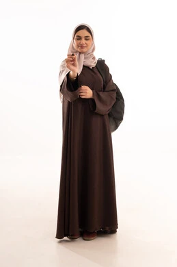 Training on writing on a board, using modern and advanced technical devices, a portrait of a Saudi Arabian Gulf woman wearing a hijab and an abaya, carrying a backpack and working on a mobile device, a young Saudi woman completing tasks, full-body, white background.