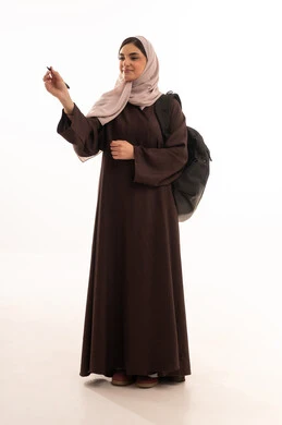 Representation of writing on a board, use of modern and advanced technical devices, portrait of a Saudi Arabian Gulf woman wearing a hijab and an abaya, carrying a backpack and working on a mobile device, a young Saudi woman completing tasks, full-body, white background.