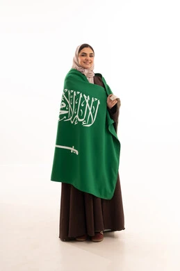 Commemoration of the Saudi National Day on September 23, Flag Day on March 11, celebration of national occasions, raising the banner of monotheism and Islam, a portrait of a Saudi Gulf Arab woman in a hijab holding the green Saudi flag in her hand, pride and honor in belonging to the homeland, full-body image, white background.