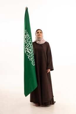 Pride in the country's achievements, raising the banner of monotheism and Islam, celebrating national occasions, pride in belonging to the homeland, commemorating Saudi National Day on September 23, Flag Day on March 11, a portrait of a Saudi Gulf Arab woman in a hijab holding the Saudi flag in her hand, full body length, white background.
