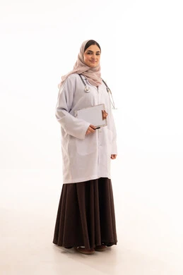The concept of medicine and healthcare, working in the health sector, a portrait of a Saudi Arabian Gulf female doctor wearing a colorful abaya and a medical coat, recording and documenting patient information, providing therapeutic services in medical centers and hospitals, full-body image, white background.