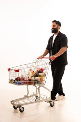 Buying necessary supplies and essentials, enjoying shopping in malls and commercial centers, benefiting from discounts and sales on products, a portrait of an Arab Gulf Omani man wearing casual attire standing with a shopping cart in front of him, full body, white background.